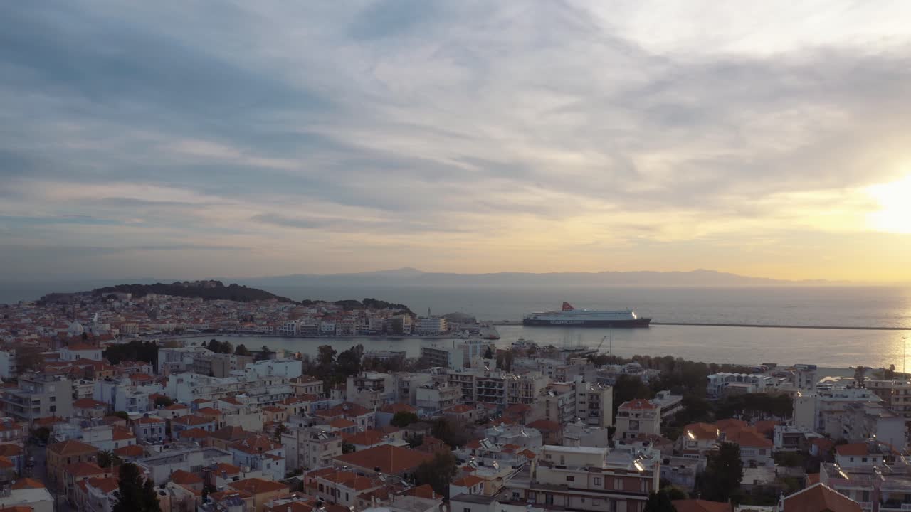 Aerial View Of A Calm Sea and Different Buildings During Sunset - Aerial Shot