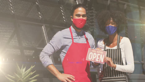 video of digital interface over diverse man and woman wearing face masks in restaurant