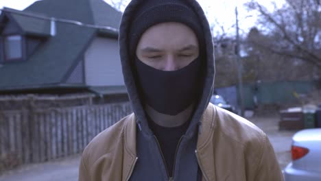 man in the street wearing facemask looking at the camera