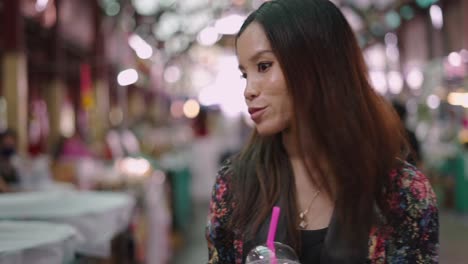 Young woman exploring a vibrant Asian market