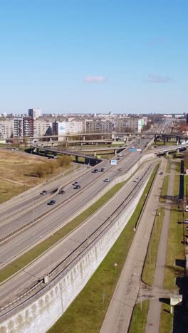 vertical drone view of busy road, drivers commuting to work, rising, riga