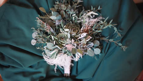 artistic teal-toned floral bouquet. wedding details