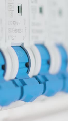 man flipping a single circuit breaker switch on and off. electrical cabinet. extreme close up