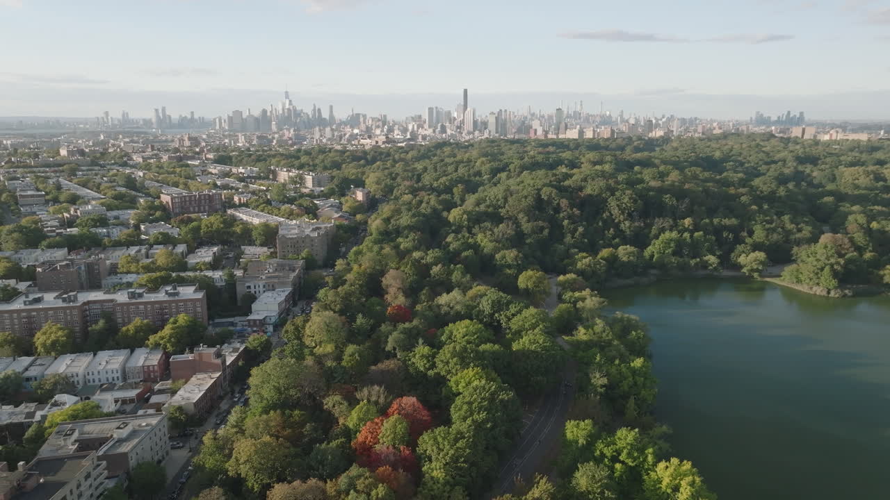 Aerial View of City Skyline with Park and Lake