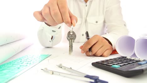 businessman handing keys of new house