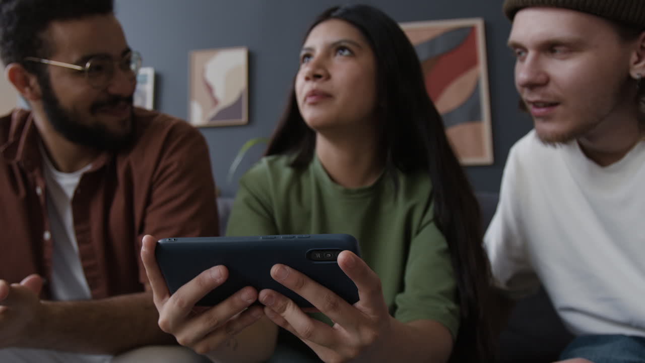 Friends sharing and discussing content on a smartphone