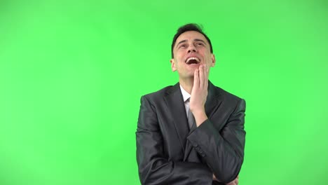 Man in a suit expressing various emotions on a green screen