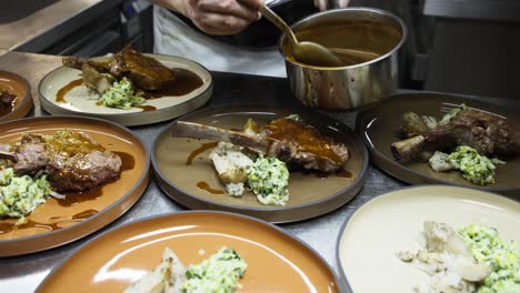 Slow-Motion-Shot-of-Chef-Spreading-Sauce-on-Steak-in-Fine-Dining-Kitchen