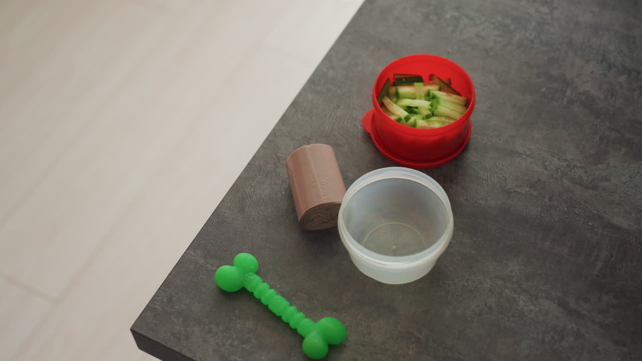Woman Fills Container With Cucumber Salad, Person Transfers Cucumber Salad Into Portable Container For Lunch, Woman Carefully Scoops Fresh Cucumber Salad Into Red Container For Her Workday Meal