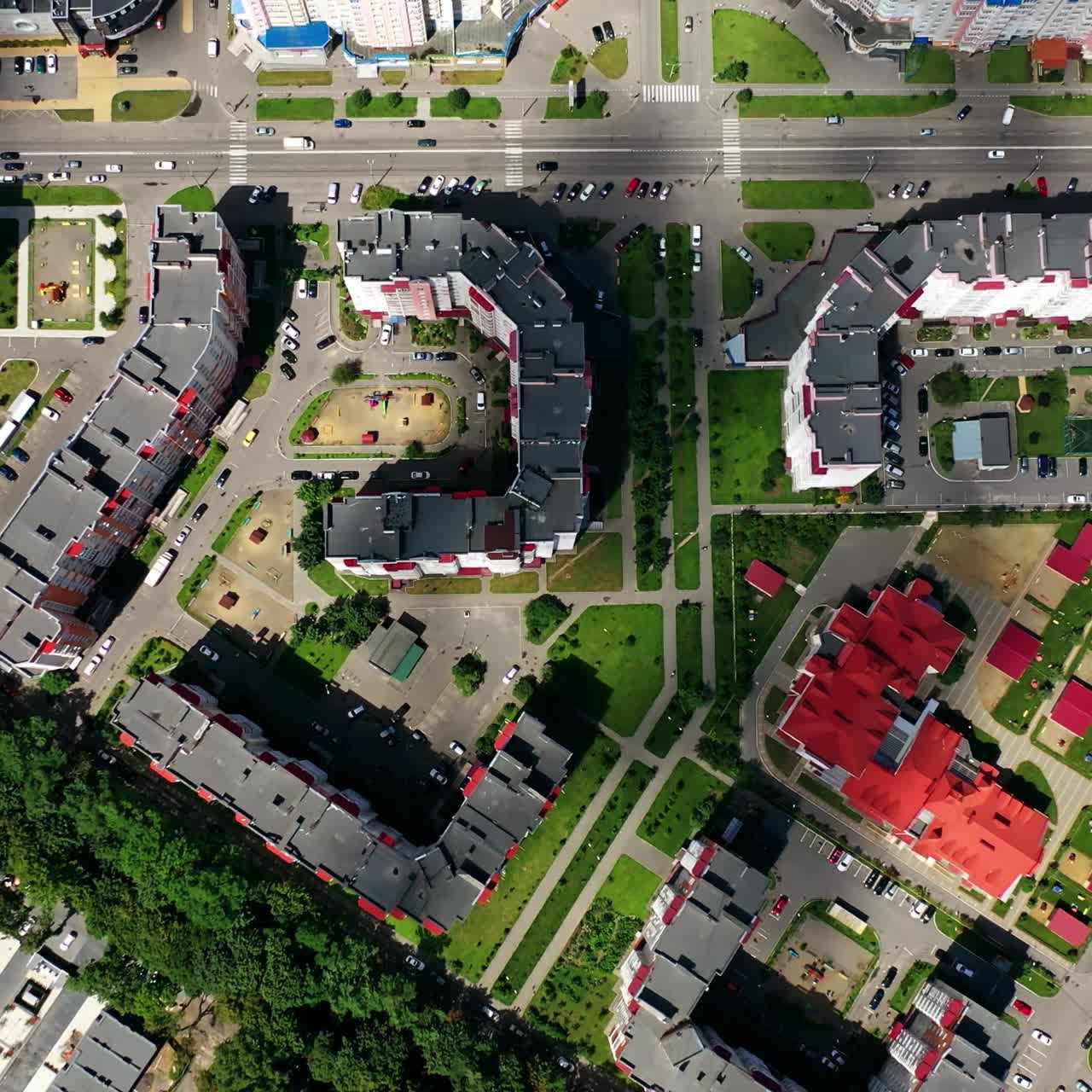 Cityscape from above. Modern downtown. Rooftops of architectural buildings in urban district. Motion camera to the right.
