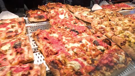 freshly baked pizzas being prepared and served