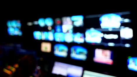 professional sound engineer's console. television broadcast, working with video and audio mixer, control broadcast in recording studio. blurred background, monitors.