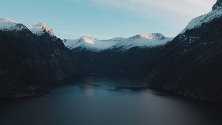 Vista panoramica di Geirangerfjord, Norvegia, un fiordo norvegese con montagne imponenti e scogliere a picco, le cui cime sono innevate in una fredda giornata invernale in Norvegia