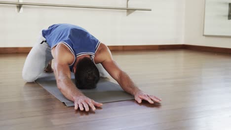 Hombre-Caucásico-Enfocado-Practicando-Yoga-En-El-Gimnasio,-Cámara-Lenta