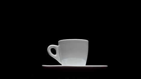 a cup of hot coffee on a black background