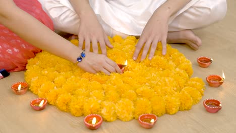 indian couple decorating home for diwali