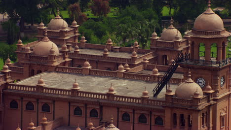 aerial close up view of a beautiful old heritage building, beautiful park and trees around the building