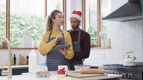 Feliz-Pareja-Diversa-Horneando-Galletas-Navideñas-En-La-Cocina-De-Casa,-En-Cámara-Lenta