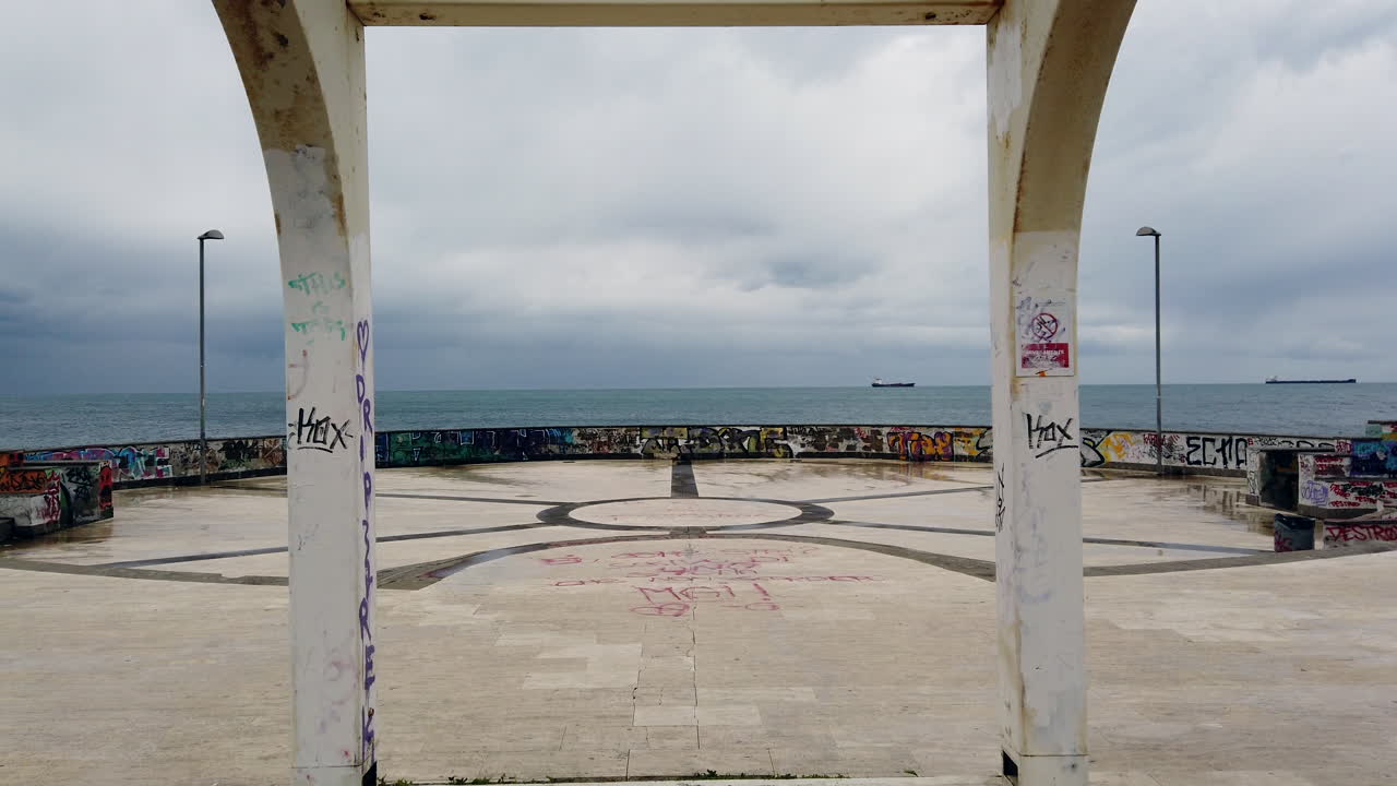 Overcast Day at the Seaside: A Walkway with Arches