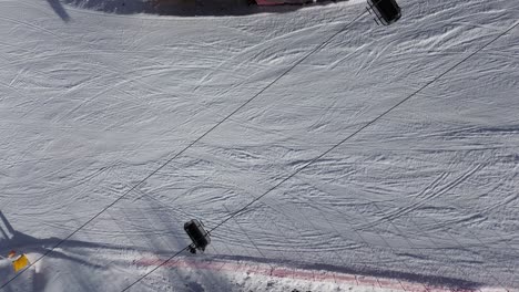 there are winter sports that play the role of the winter olympics in cortina and milano italy. learning to ski and snowboard i capture these videos with my drone that is in a ski resort. from sky