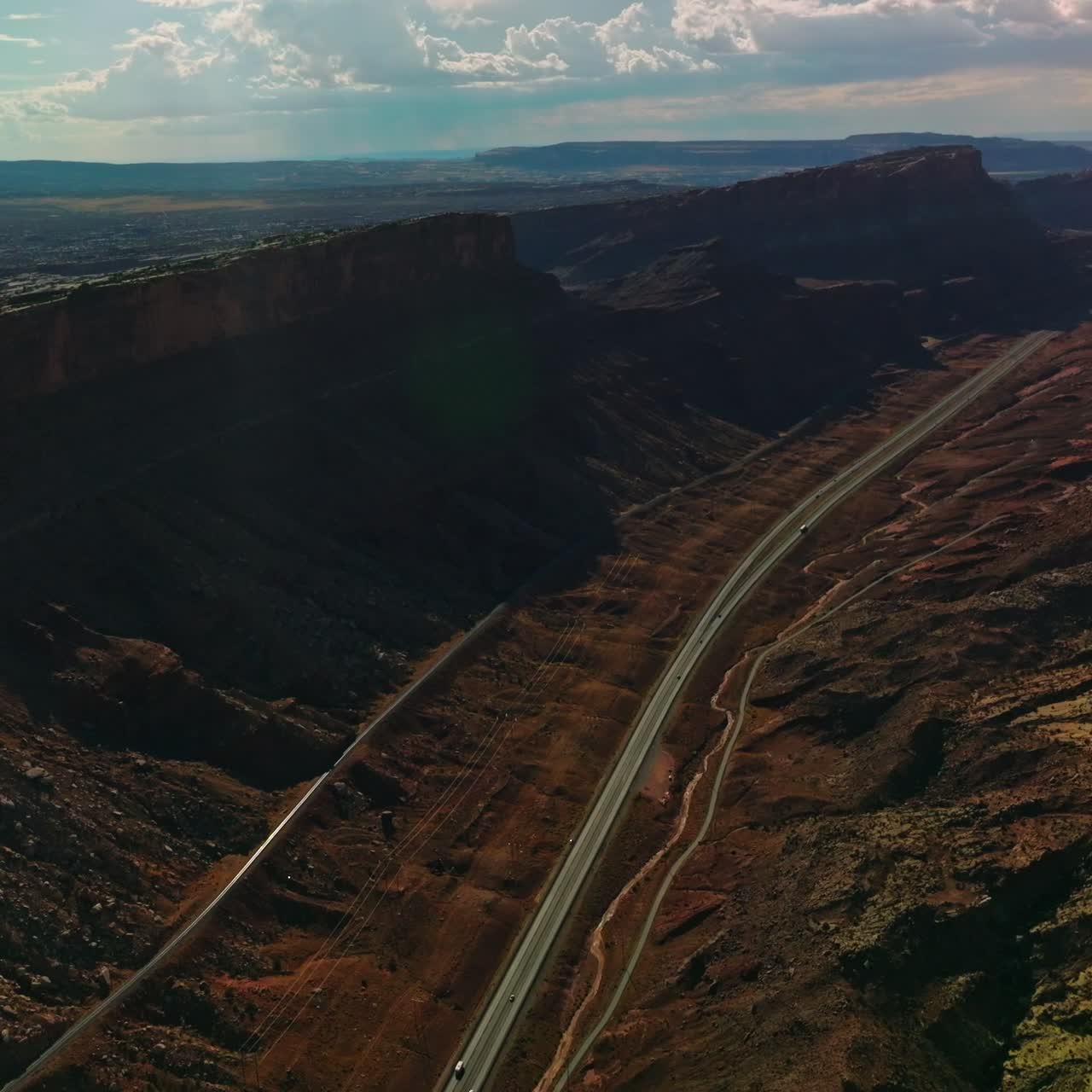 Splendid relief in the Utah National Park. Amazing scenery of rocks and valleys lit by sun from aerial perspective