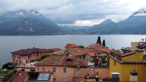 drone volando sobre tejados y casas en un pequeño pueblo en el lago de como