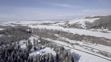 aerial-over-country-road-in-snowy-valley