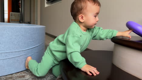 baby crawling and playing with a purple toy