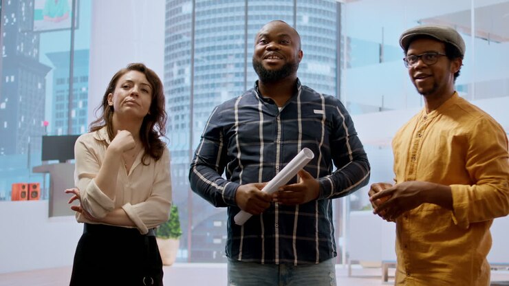 Real estate broker and client analyzing blueprints for an office space