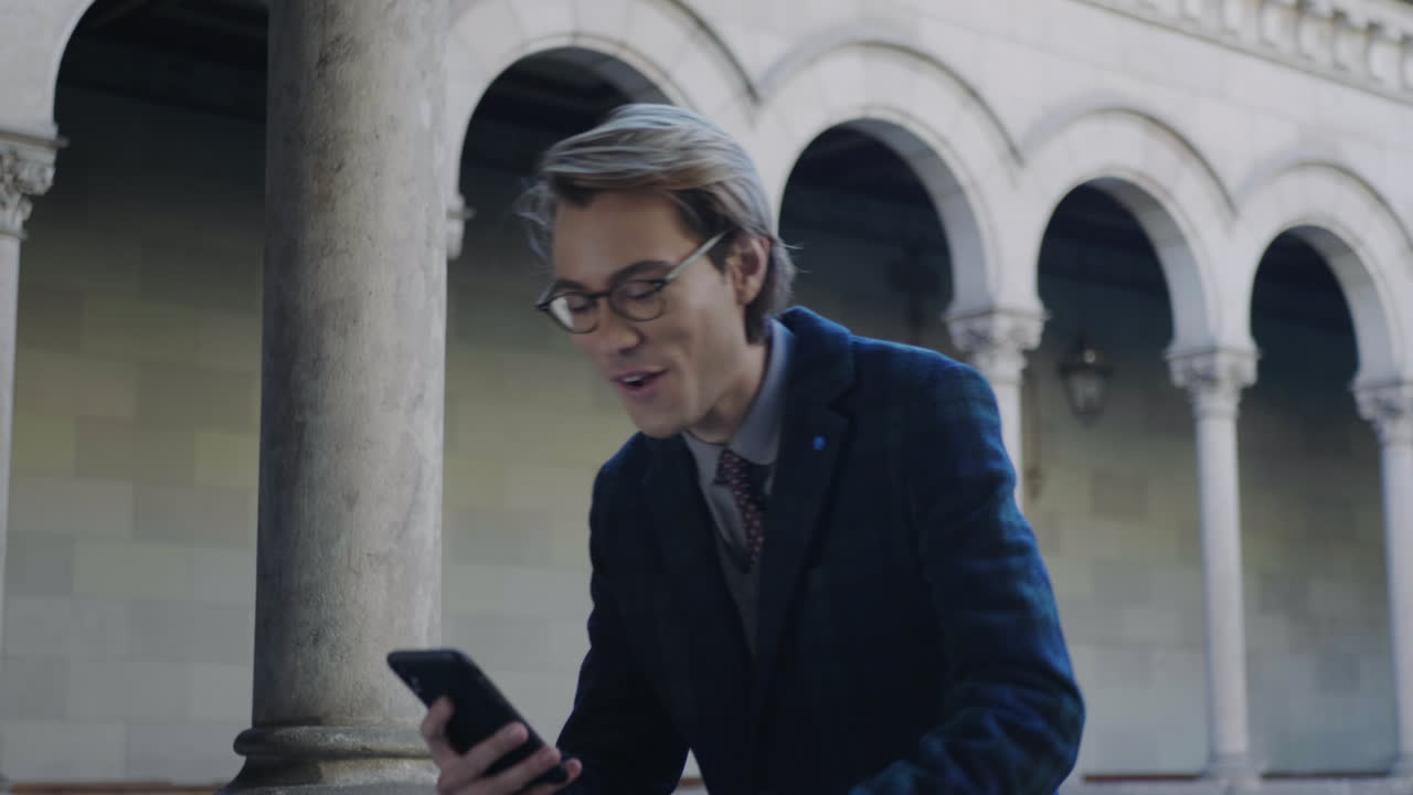 Student receiving good news on smartphone