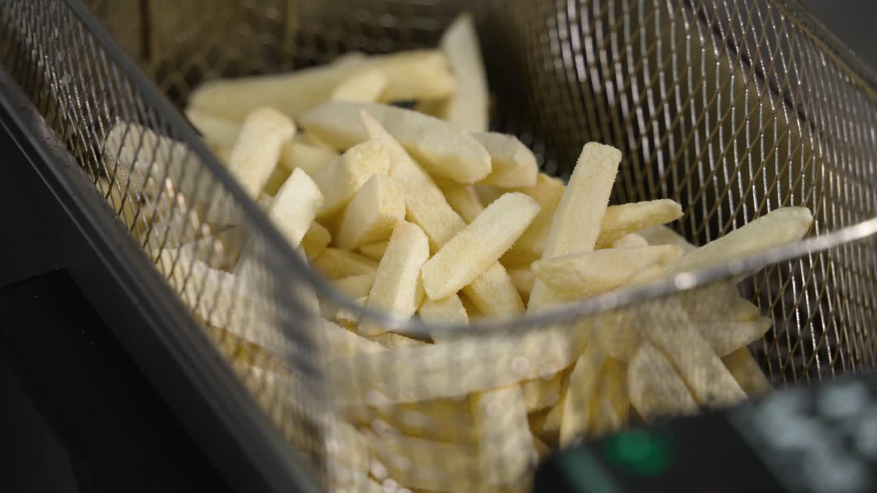 French Fries Being Fried in a Deep Fryer