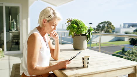 Mature-woman,-coffee-and-remote-working-tablet