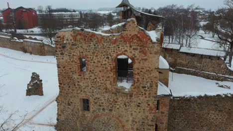 ruins of ancient livonian order's stone medieval castle latvia aerial drone top shot from above . restored castle capella at winter in dobele city. 4k resolution