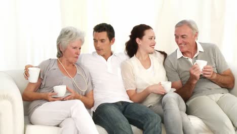 Parents-and-grandparents-drinking-coffee-on-the-sofa