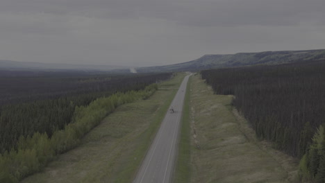 truck cruising through the beautiful wilderness of alaska highway.