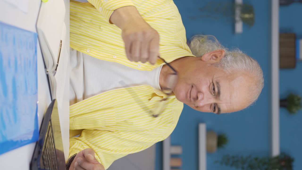 홈 오피스 근로자 노인의 수직 비디오는 재미있고 유쾌합니다.