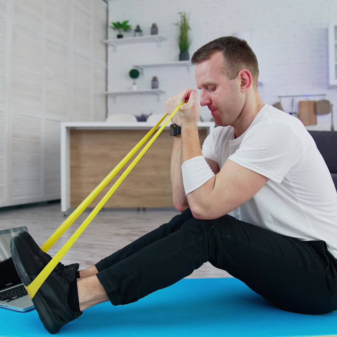 Handsome athletic man doing exercise in home. Indoor training on quarantine