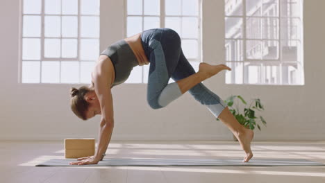 healthy yoga woman practicing three legged downward facing dog pose enjoying fitness lifestyle exercising in studio stretching beautiful body training on exercise mat at sunrise