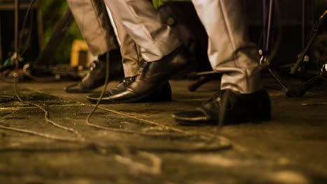 low angle shot of a band performing and dancing on stage in perfect synchronisation