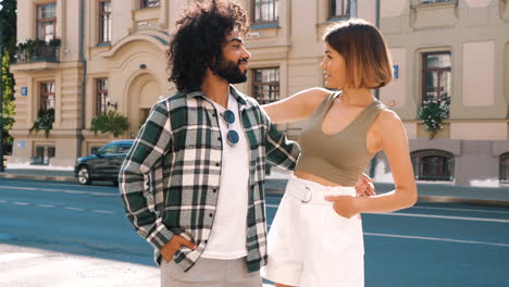 couple walking and hugging on the street