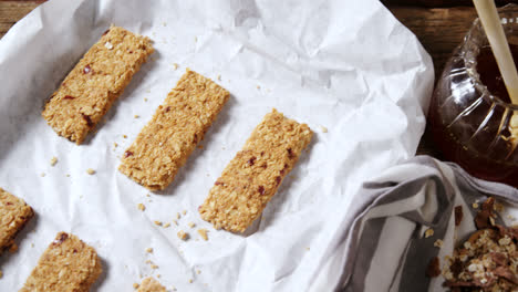 granola bars and honey on wooden table 4k