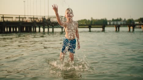 slow-mo: little kid splashing water at camera