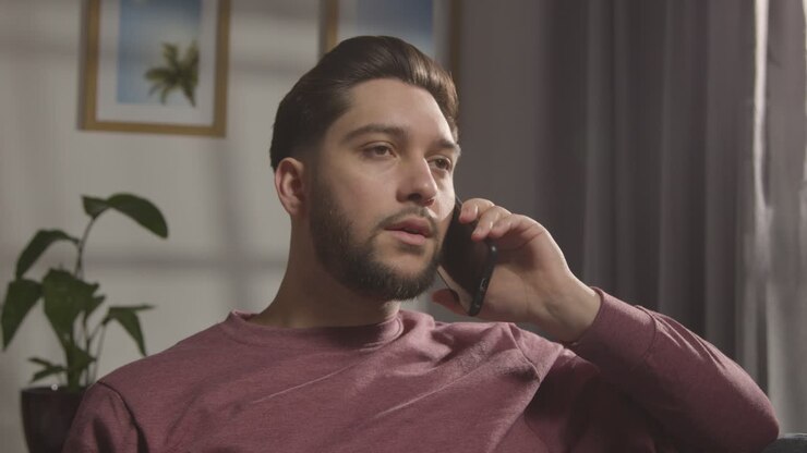 Pleased Young Man At Home Receiving Phone Call Confirming Job Offer 4