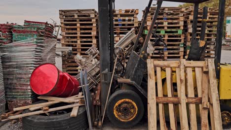 forklift truck in freight handling yard with transport shipping pallets