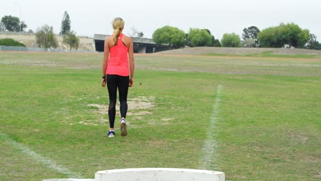 Rear-view-of-Caucasian-female-athlete-walking-on-the-sports-field-4k