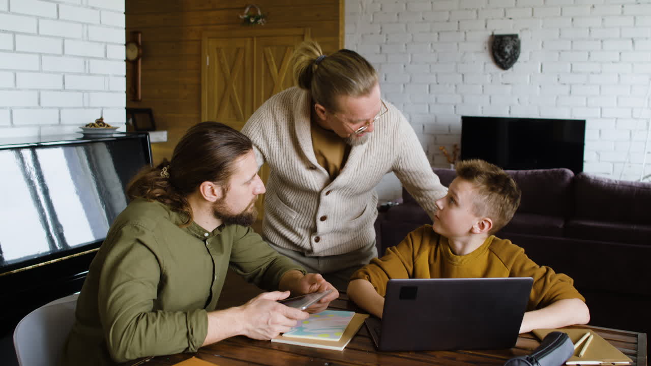 Caucasian man and boy in the living room