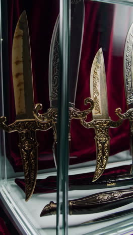 ornamental knives in a display case