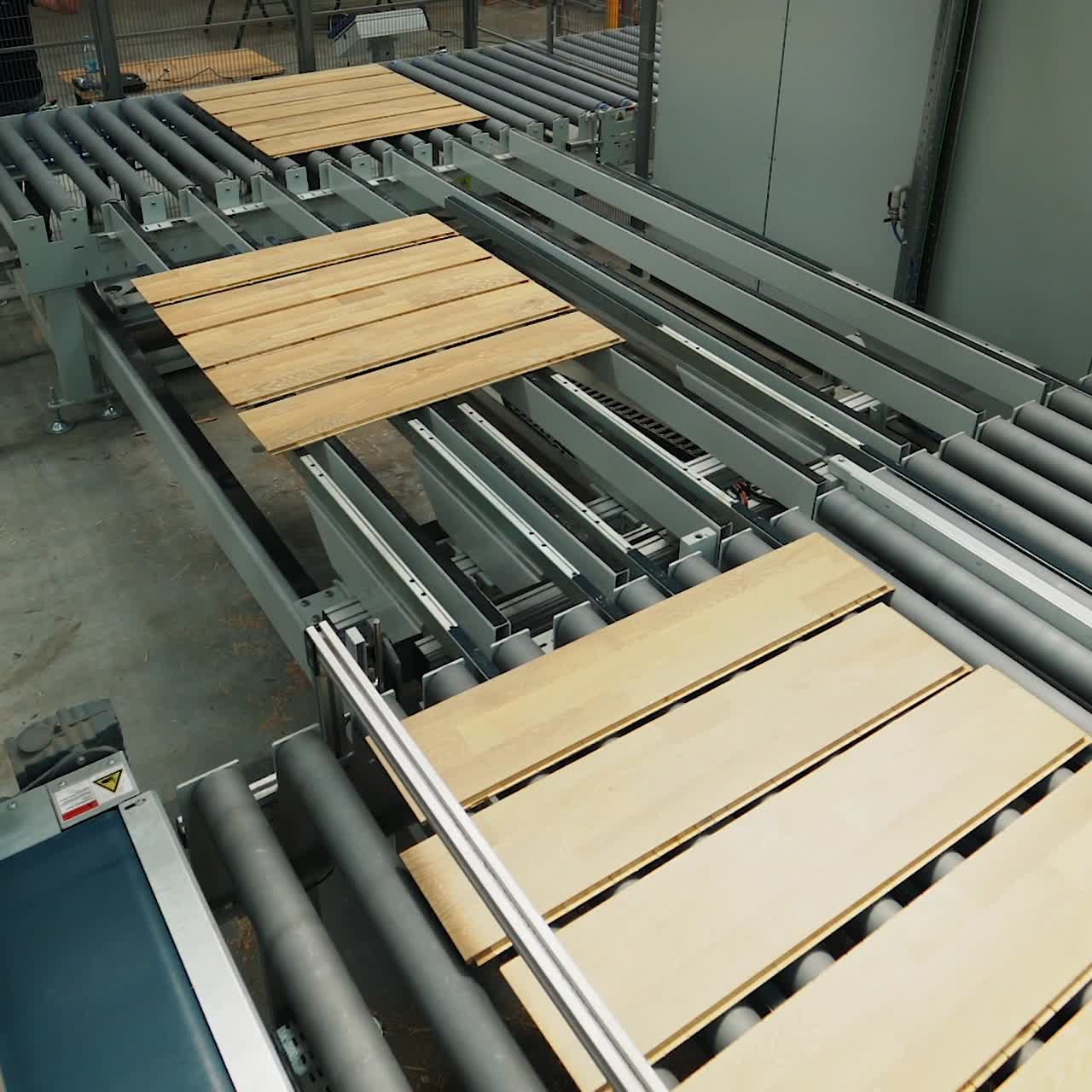 wooden boards are processing at the automated line of plant for the parquet manufacturing. Woodworking industry