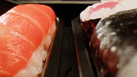 close-up of sushi and nigiri in a takeout box