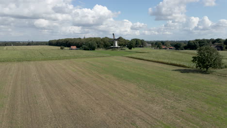 jib up of traditional windmill surrounded by green meadows